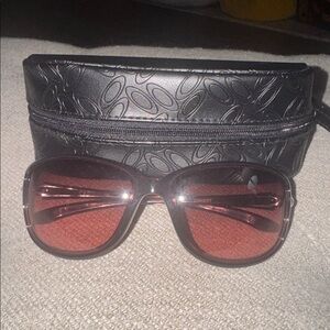 NWOT, Oakley women’s sunglasses in a beautiful wine / zip case wristlet .